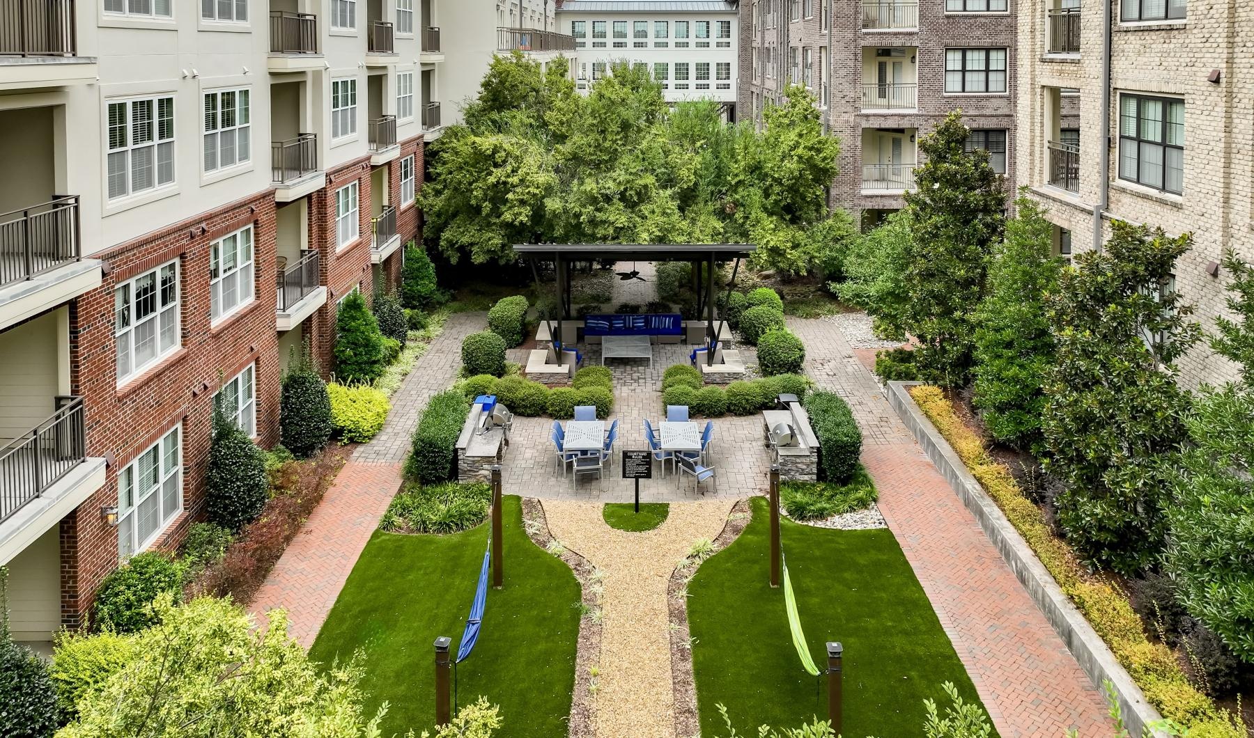 Find your perfect fit at Berkshire Ninth Street a courtyard with trees and buildings around it