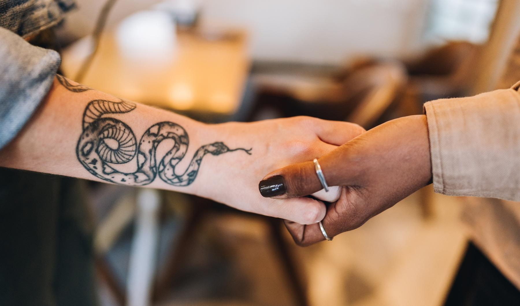 a person's hand with a tattoo on it