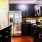 a kitchen with black cabinets