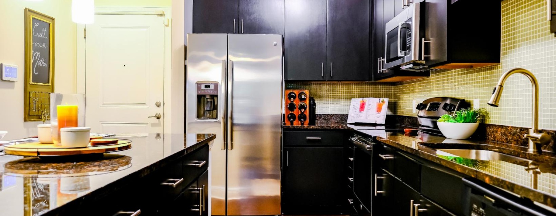 a kitchen with black cabinets