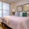 a bedroom with a bed and a lamp