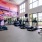 a room with exercise equipment and a wall with art on it