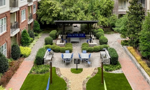 a courtyard with trees and buildings around it