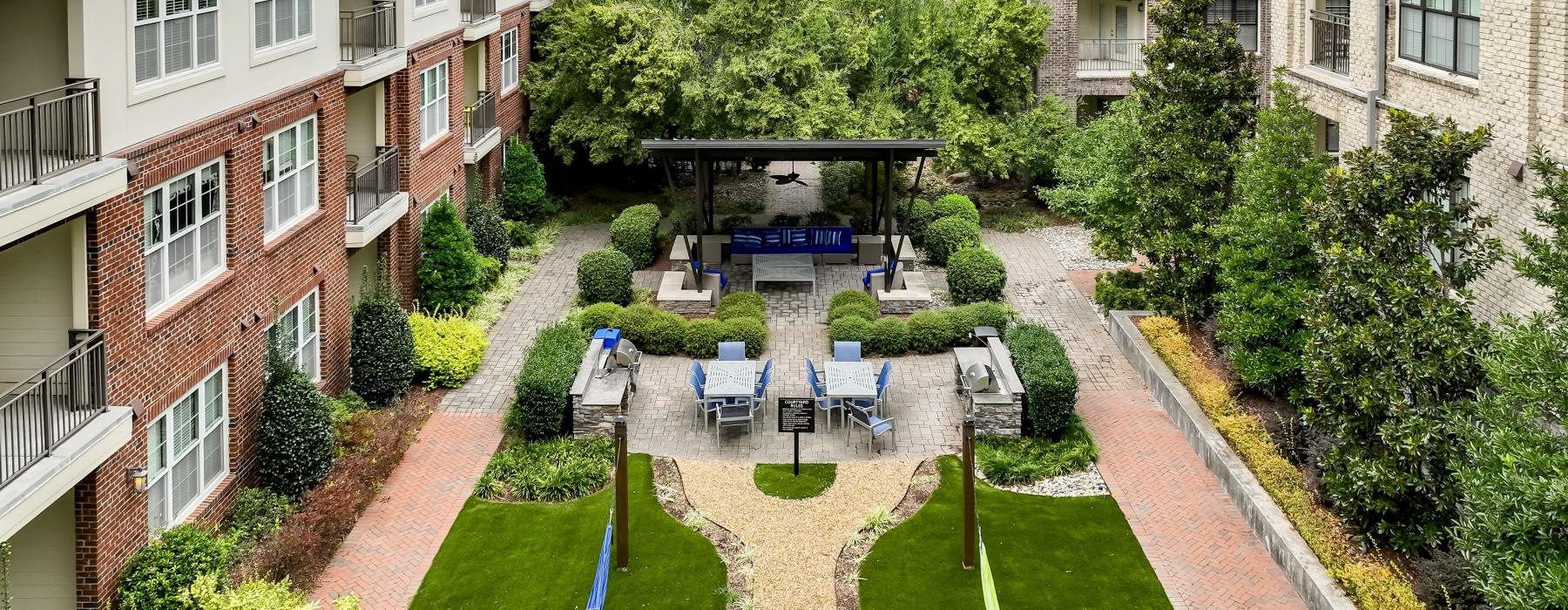 a courtyard with trees and buildings around it