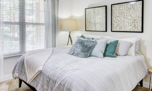 a bed with a white bed spread